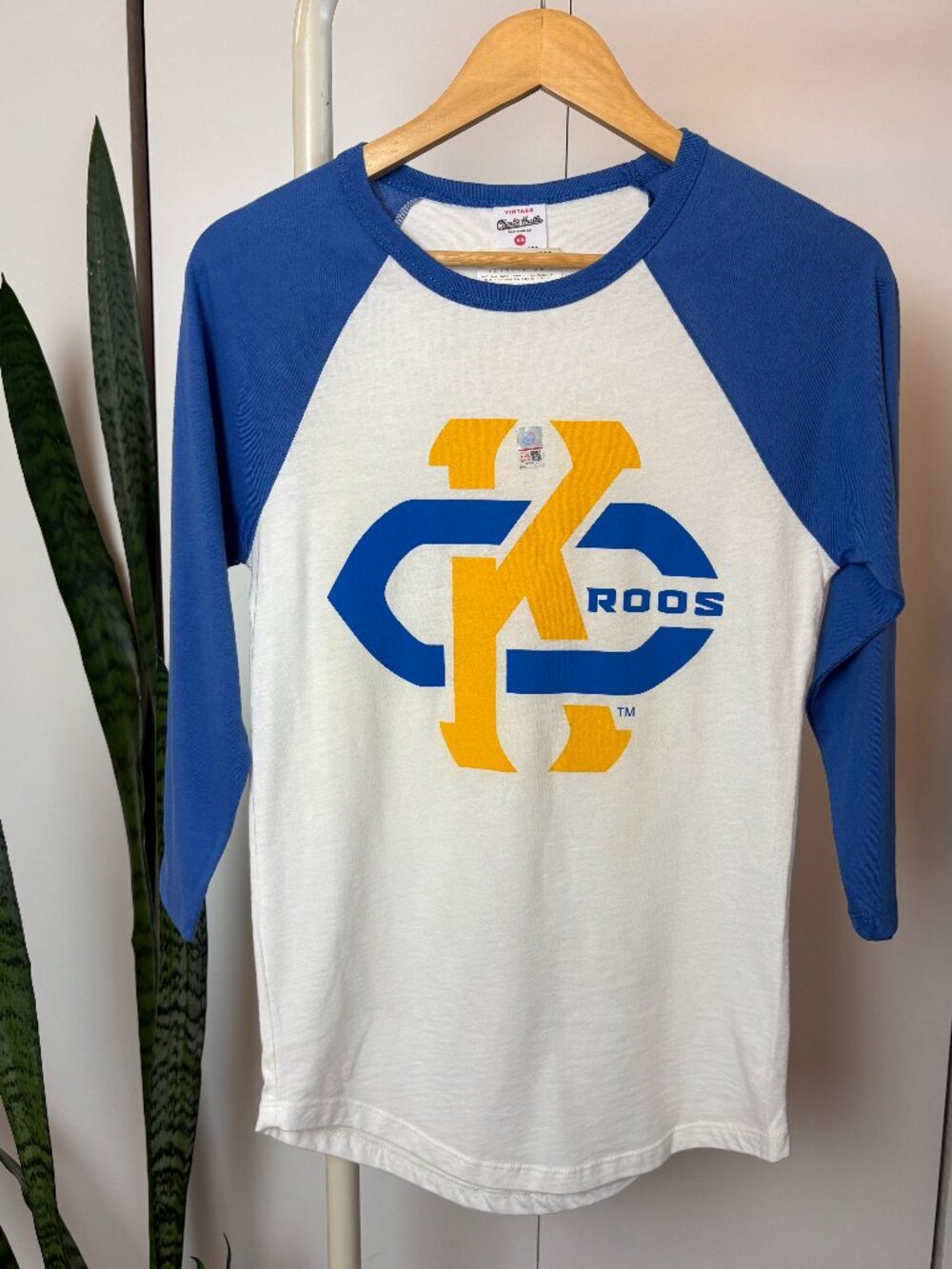 Charlie Hustle UMKC Blue and White Raglan Long Sleeve Tee with Yellow Graphic